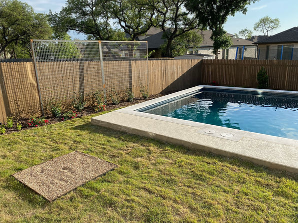 This client knew they were installing a pool and would need help regrading the landscape and creating some beds. We installed a few trees and a trellis for privacy around the pool. Then, we smoothed out the soil for all the grass areas and installed a new zoysia grass that will grow well in their sunny yard. We also added a shade tree in the corner to grow up and add some more afternoon shade.