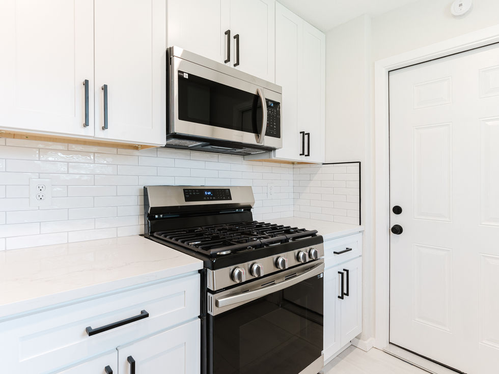 a kitchen with a stove top oven and a microwave