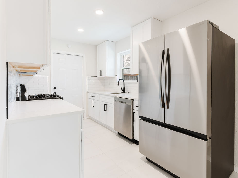 a kitchen with stainless steel appliances and white cabinets