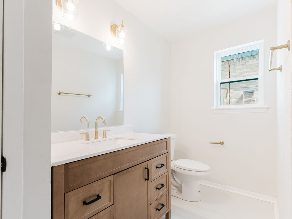 a bathroom with a sink and toilet and a window