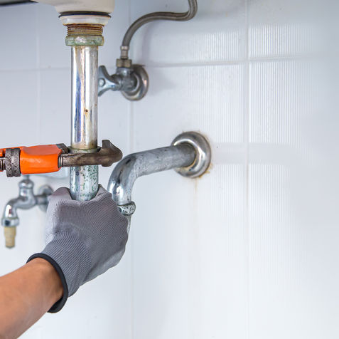 plumber-using-wrench-repair-water-pipe-sink (1).jpg