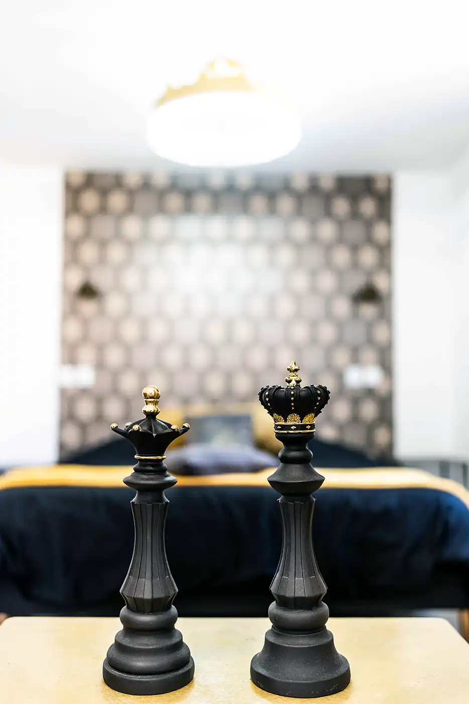 Photo immobilier montrant 2 pièces d'échecs devant un grand lit