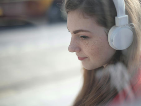 A woman wearing white headphones
