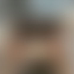 Hands on a laptop with coffee and juice next to the laptop on a table