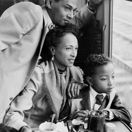 Windrush Generation man, woman and child on a train in the UK
