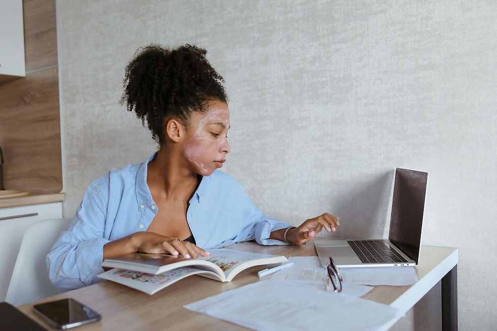 A woman with face cream working at her desk