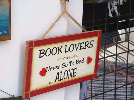 A Plaque on a wall saying Book Lovers Never Go To Bed Alone