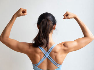 Strong woman flexing muscles