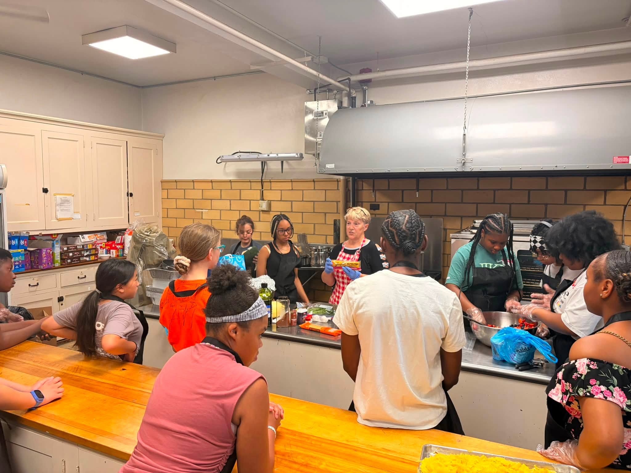 Students discovering the importance of fresh ingredients in a hands-on kitchen lesson.