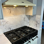 A well-equipped kitchen showcasing a stove and oven, surrounded by cabinets and kitchenware