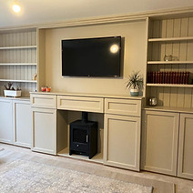 A cosy living room featuring a fireplace and built-in bookcases filled with books