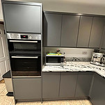  A well-designed kitchen showcasing a large island with an integrated sink, complemented by stylish cabinetry