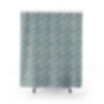 printed shower curtain with small white flowers on an aqua blue background front