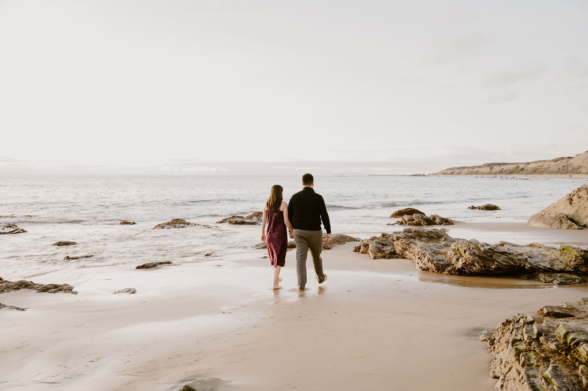 Crystal Cove State Park Beach Sunset Engagement photoshoot - couple walking along the shore
