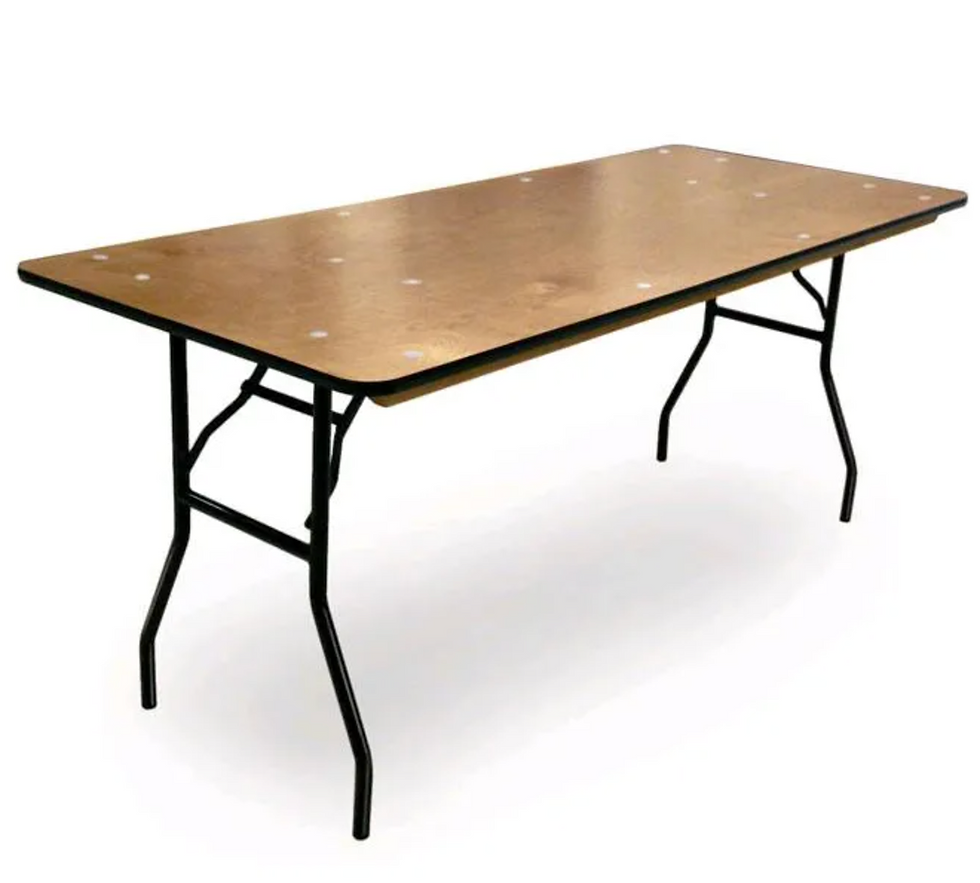 A six foot table featuring a solid wood top and sleek black legs
