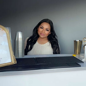 Angelica from Angelica Mobile Bar preparing drinks behind the bar for events and celebrations