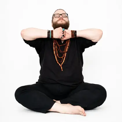 hands locked in ganesha mudra in front of throat