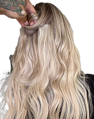 Bright, dimensional blonde balayage on long, wavy hair