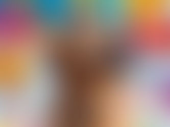 A dog smiling with colorful balloons around him