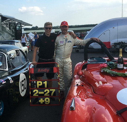 Andrew Keith-Lucas celebrating Jaguar XK win infront of covered race car transporter