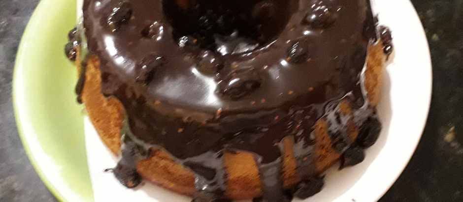 BOLO DE CENOURA COM LARANJA E GENGIBRE, COM COBERTURA DE BRIGADEIRO DE AMORAS.
