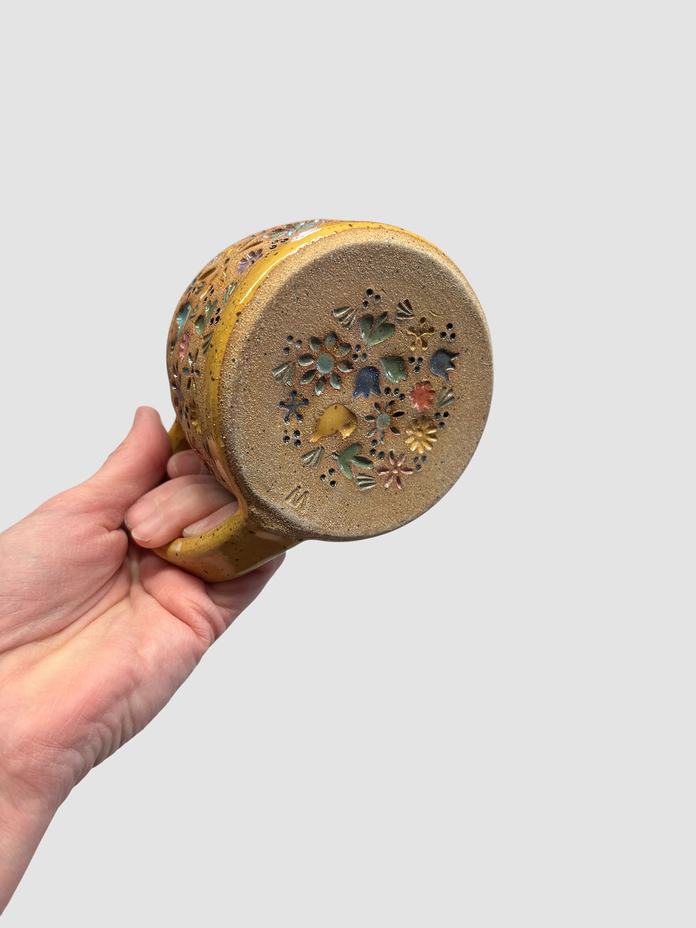 bottom of yellow folk mug