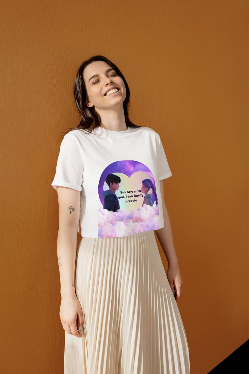 Woman smiling, wearing white crop top with anime couple design and quote: "But you were with me, and that was enough."
