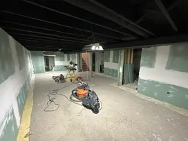 Basement renovation with drywall and construction tools