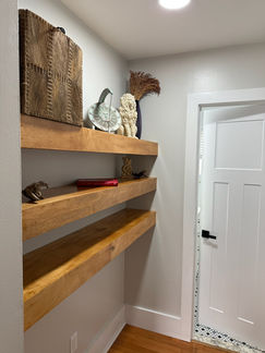 Rustic floating wooden shelves in a modern hallway