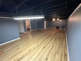 Finished basement with wood flooring and blue walls