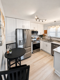 Modern kitchen with white cabinets and stainless steel appliances
