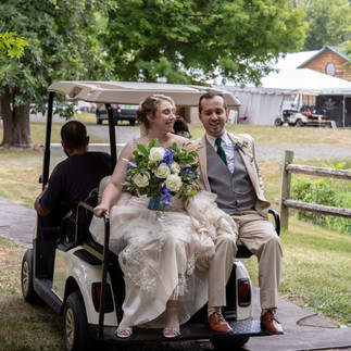 Bride and groom riding Golf cart
