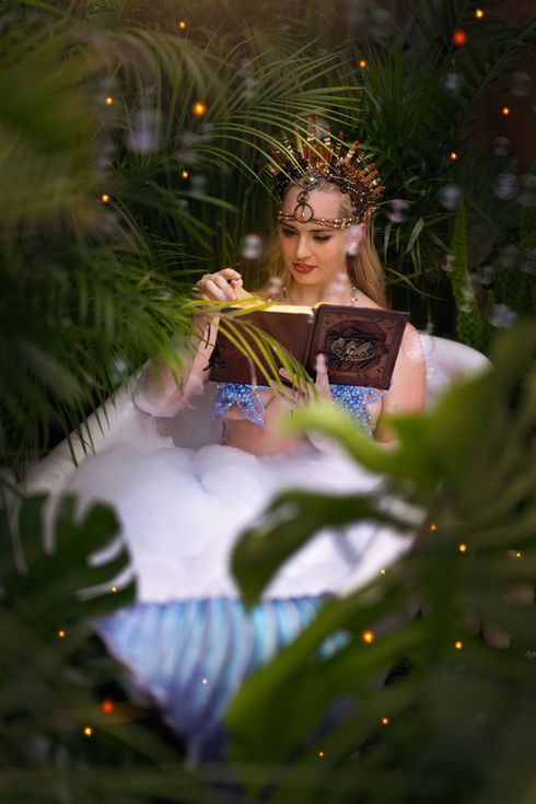 Mermaid Kalynn sits in a bubble bath, reading. Her tub is in the middle of the jungle. Bubbles fly all around her, but she is so absorbed in her book to notice. She turns the page...