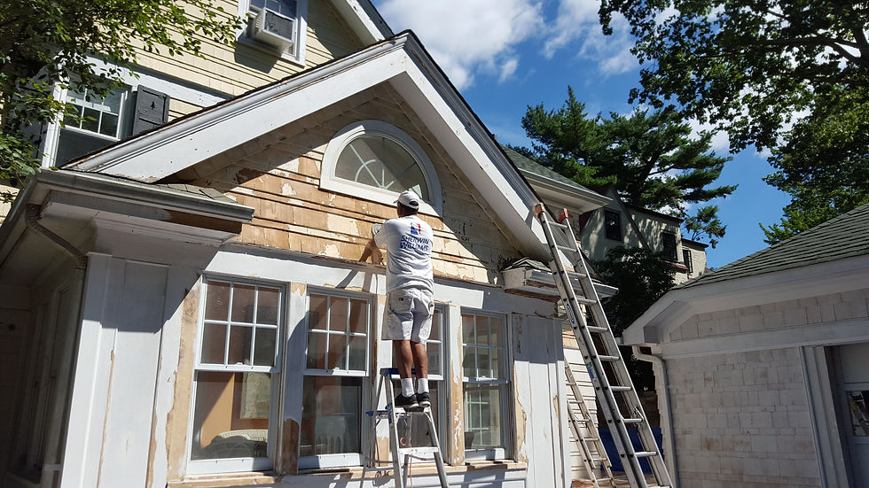 Eye-level view of a painter applying fresh color to a home exterior