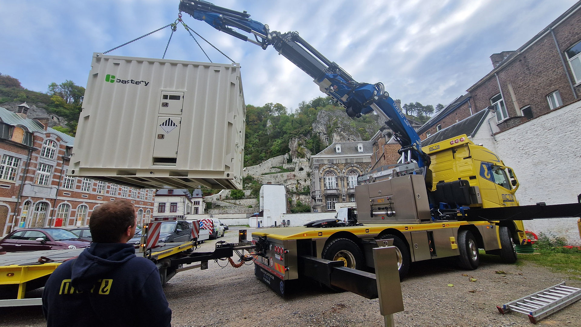 Mobile battery container being lifted off the truck to be installed on site
