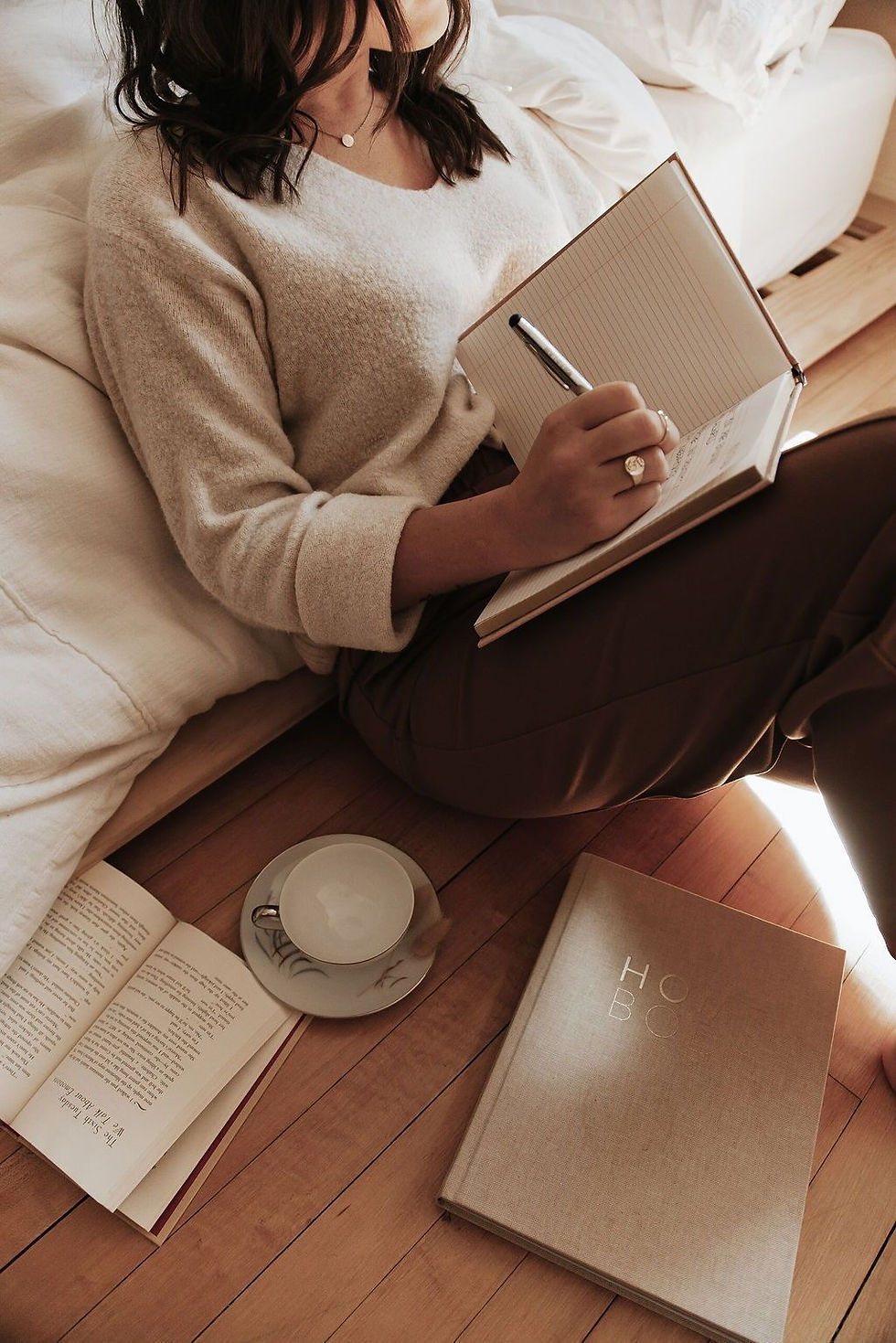A woman journaling about overfunctioning, overgiving, burnout, and self abandonment