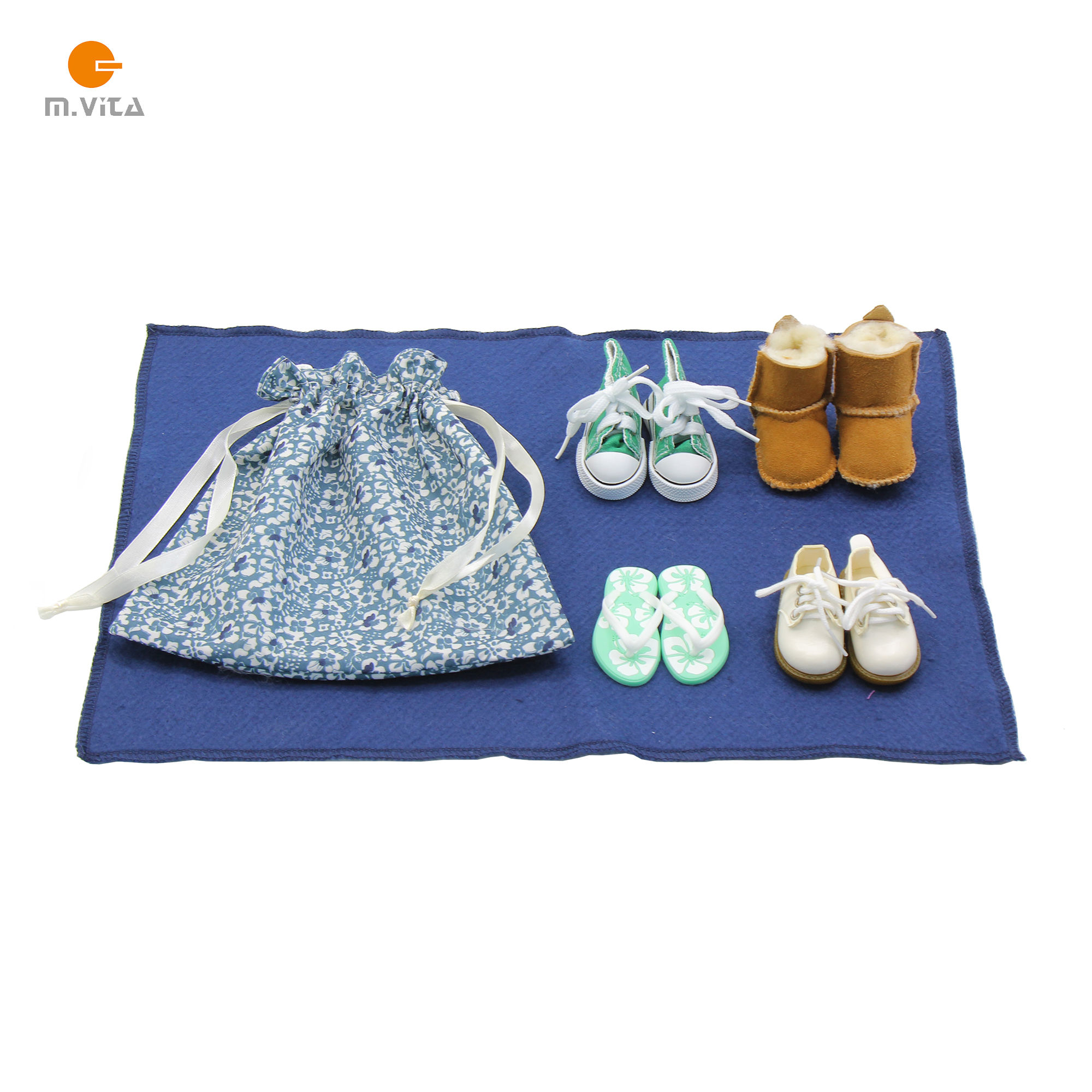 Montessori stereognostic activity set with four pairs of miniature shoes and a floral cotton drawstring bag arranged on a nav