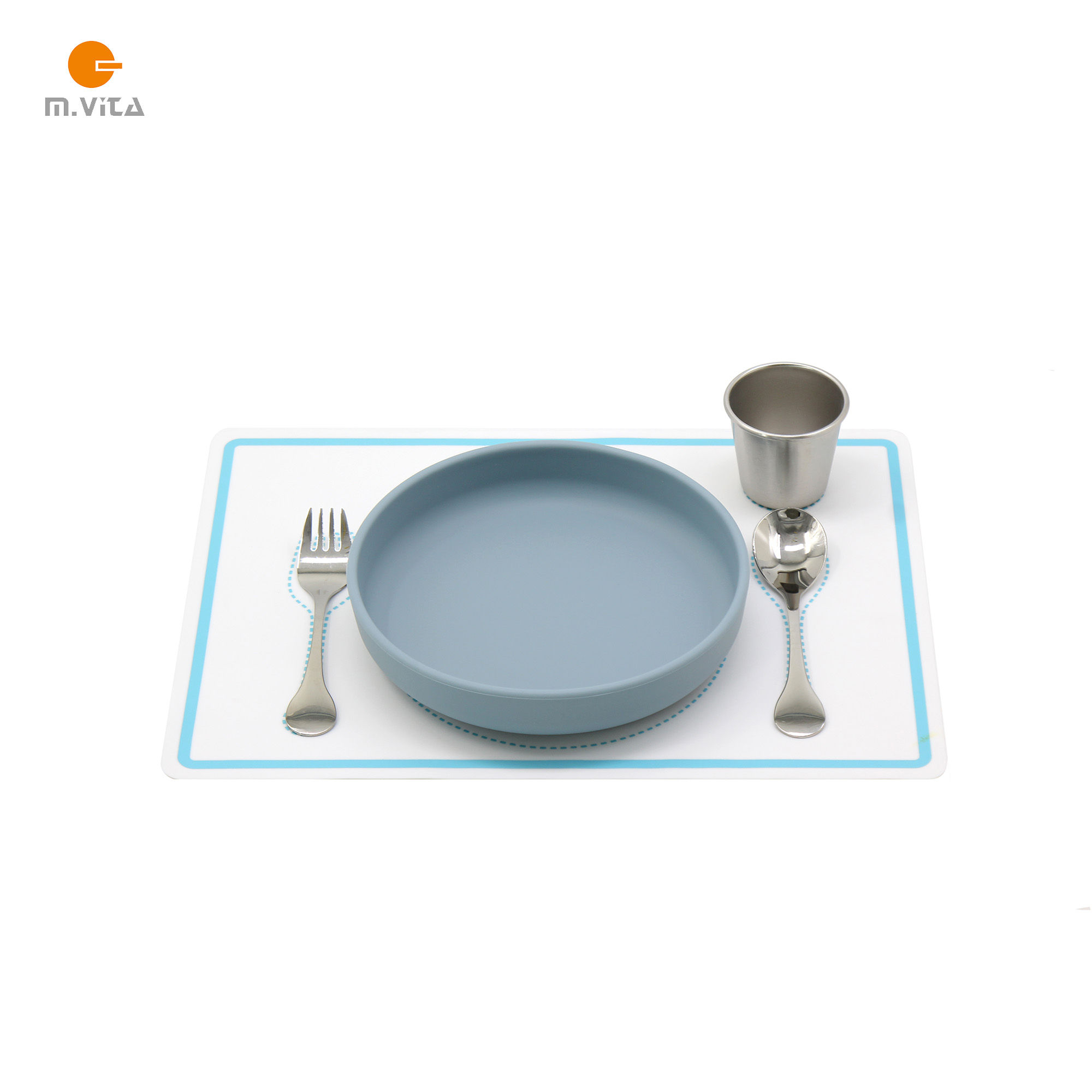 Montessori toddler dining set with silicone plate, stainless steel cup, fork, and spoon placed on a printed placemat top view