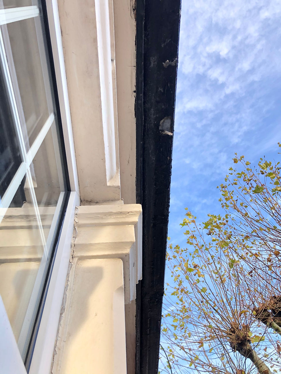 Leaking rainwater gutter causing damp to internal wall