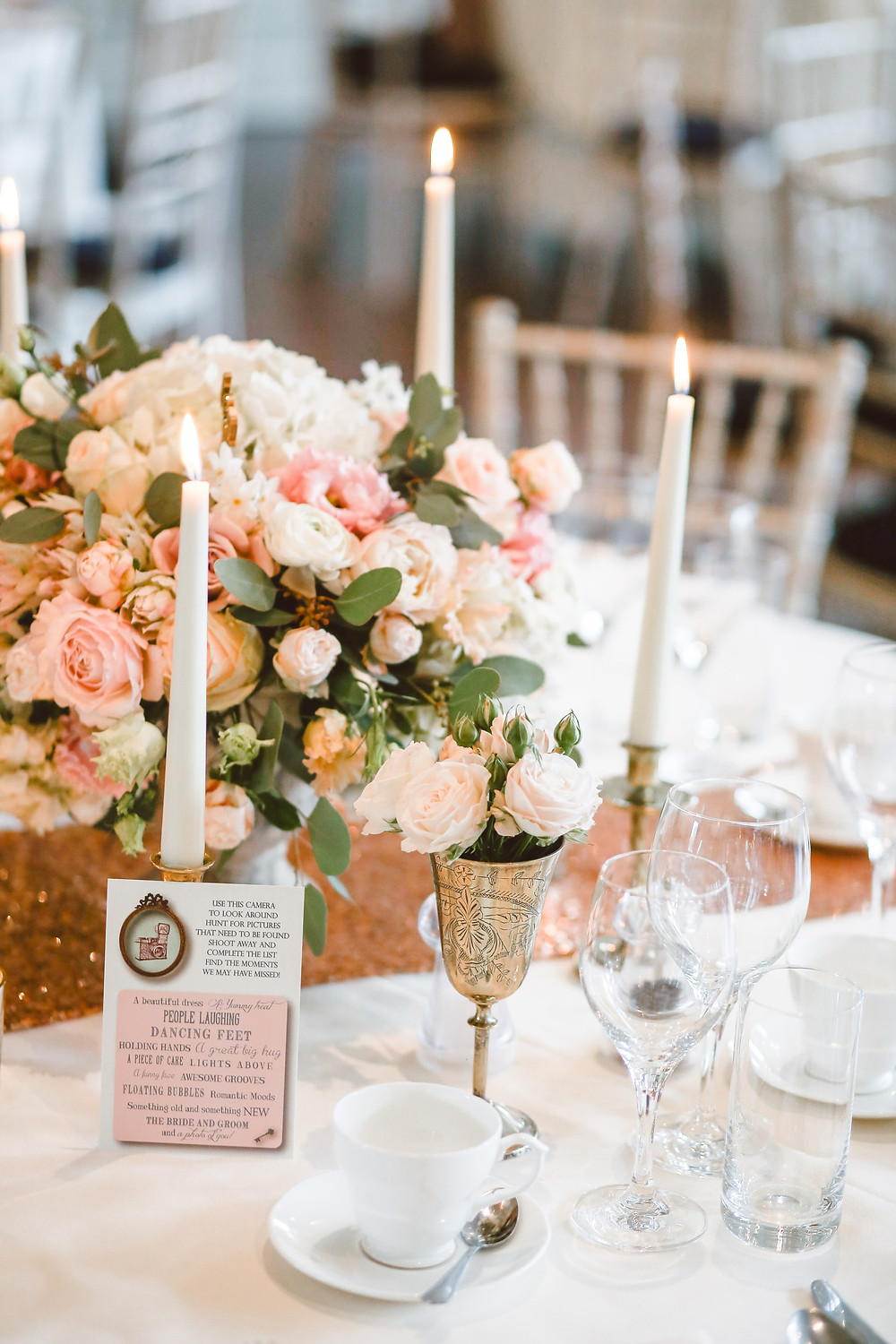 flowers on a gold wedding reception table