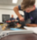 a photo of a young man working on the Biomotum SPARK device in a lab setting