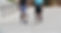 a photo of two men walking together outside on concrete and both are wearing the Biomotum SPARK device on both legs.