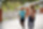 a mother and son holding hands and talking. the boy is wearing the biomotum SPARK device on both legs