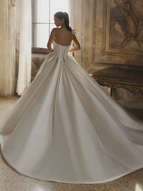 Back view of the Pen·Liv Coco bridal gown highlighting the clean lines, flowing train, and timeless ballgown silhouette.