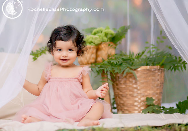 little girl outdoor cake smash white tent and cake peach dress