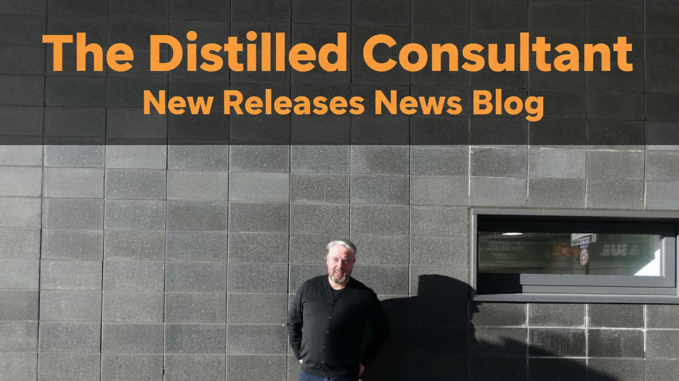 Eye-level view of a glass of whisky with amber liquid and a whisky bottle in the background