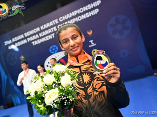 a girl holding her victory medal