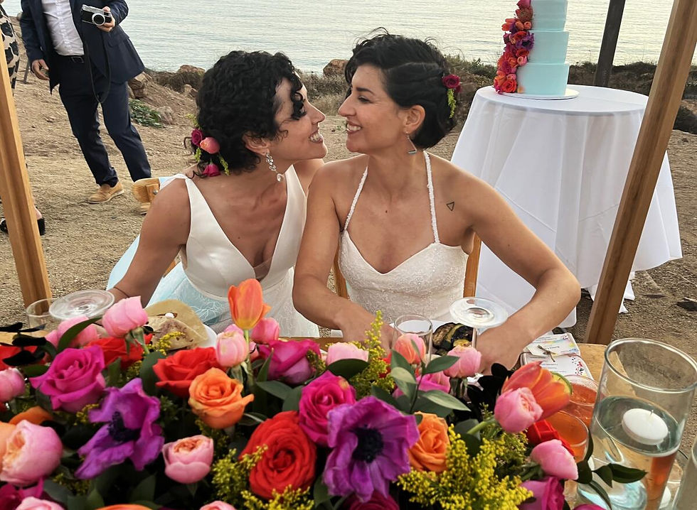 Two Women Getting Married Surrounded By Flowers