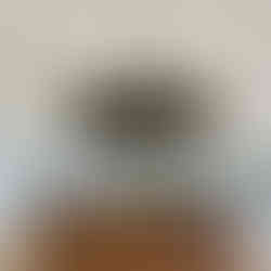 Wooden round bar in a marquee with a hanging floral arrangement