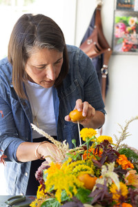 Seasonal fruit and other produce add unique accents to a floral arrangement.